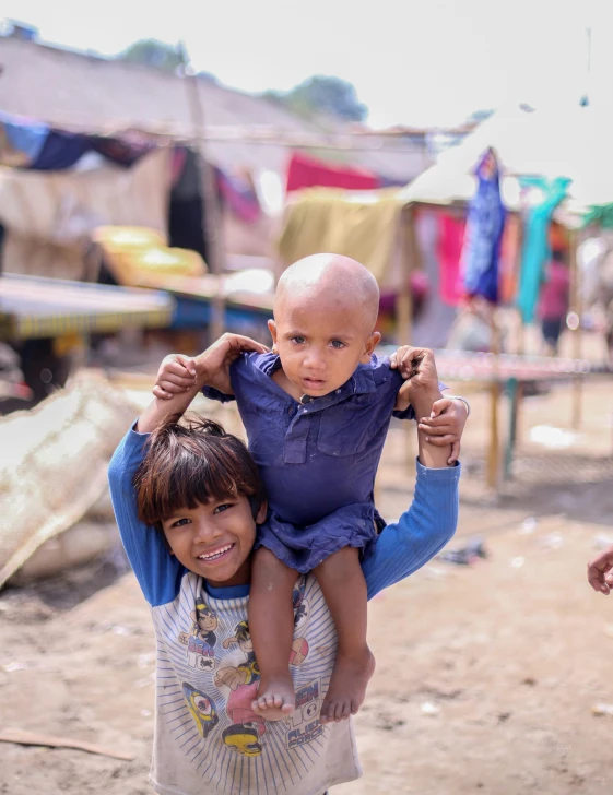 a boy on the shoulders of a girl on their shoulders