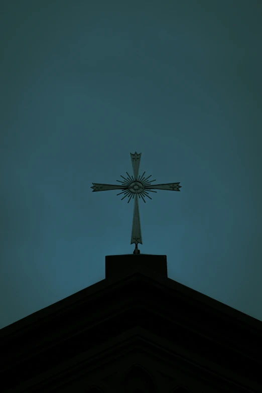 the cross is atop of the top of a building