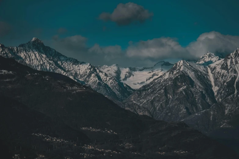 a snow capped mountain with many trees