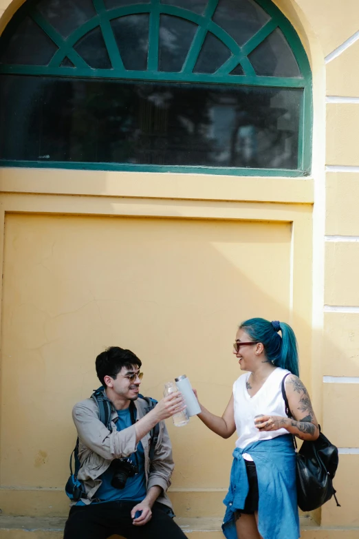 an image of a couple sitting on the steps outside