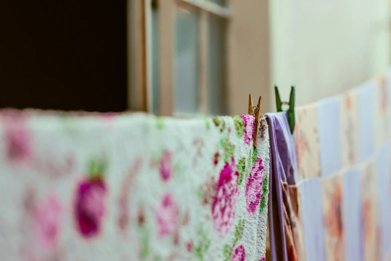 several colorfully dyed clothing hanging next to a window