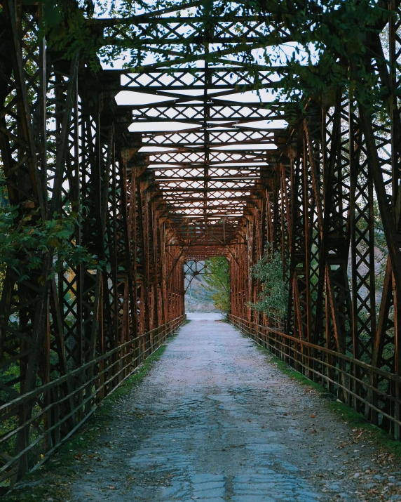 a bridge with some steel beams that have a path under it