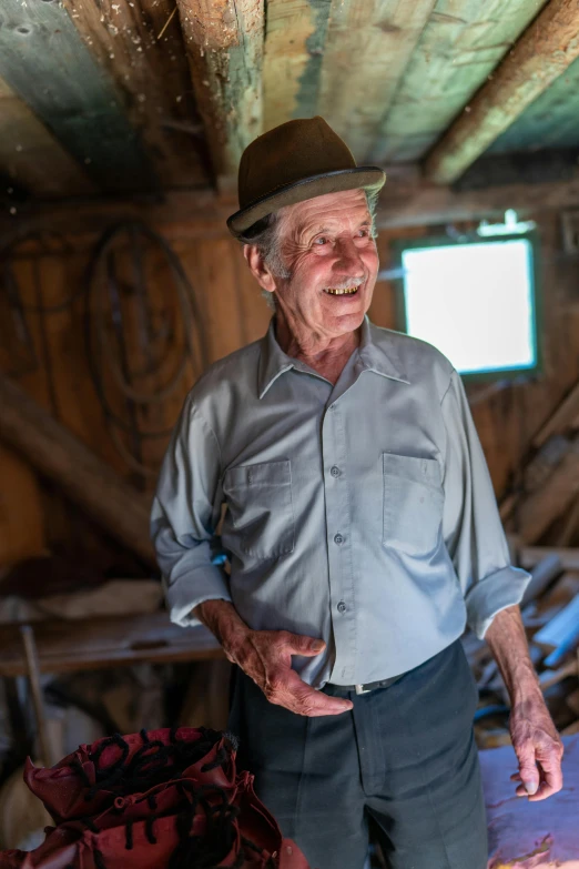 an old man standing with his hands in his pockets