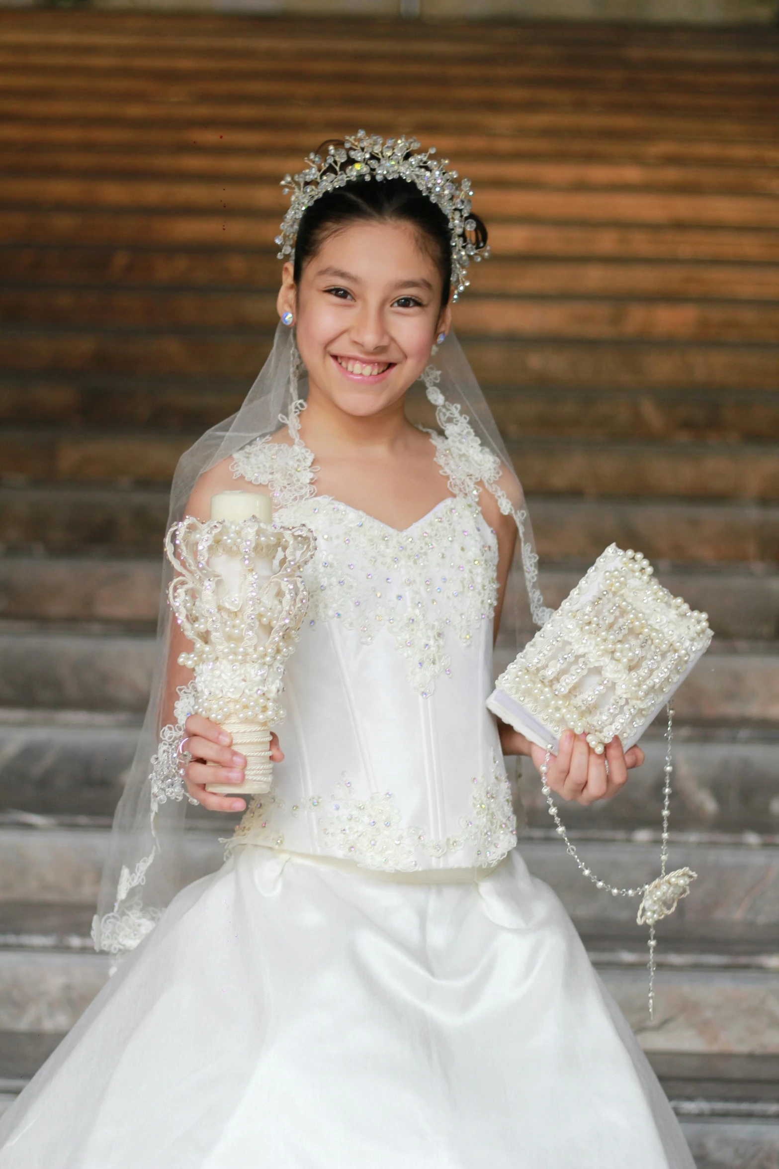 a girl dressed in white holding flowers and wearing a wedding dress