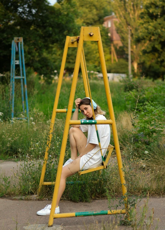 young man on swing with shoes resting against leg