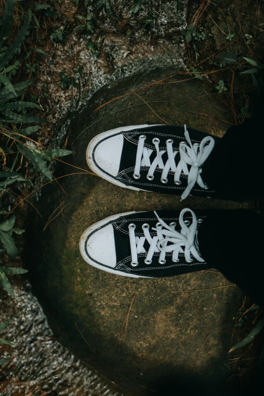 two shoes in the dark are on a rock