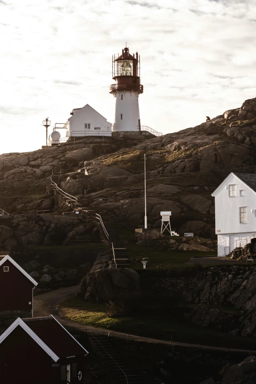 two light towers on the side of a rocky hill