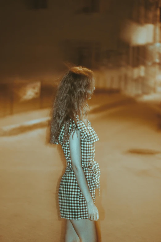 a girl walking on a street with a skateboard