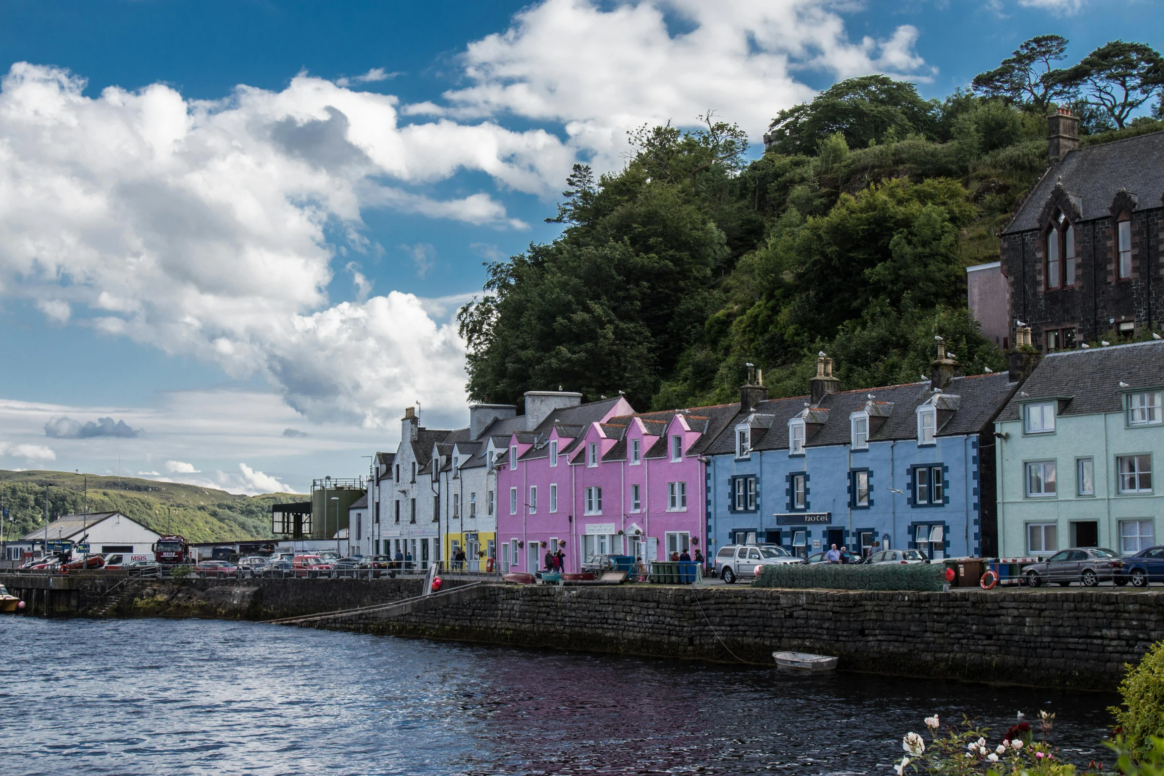 a row of houses sitting along the edge of a river