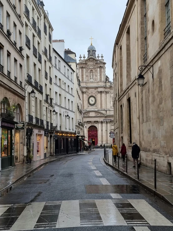 a quiet city street with people on either side