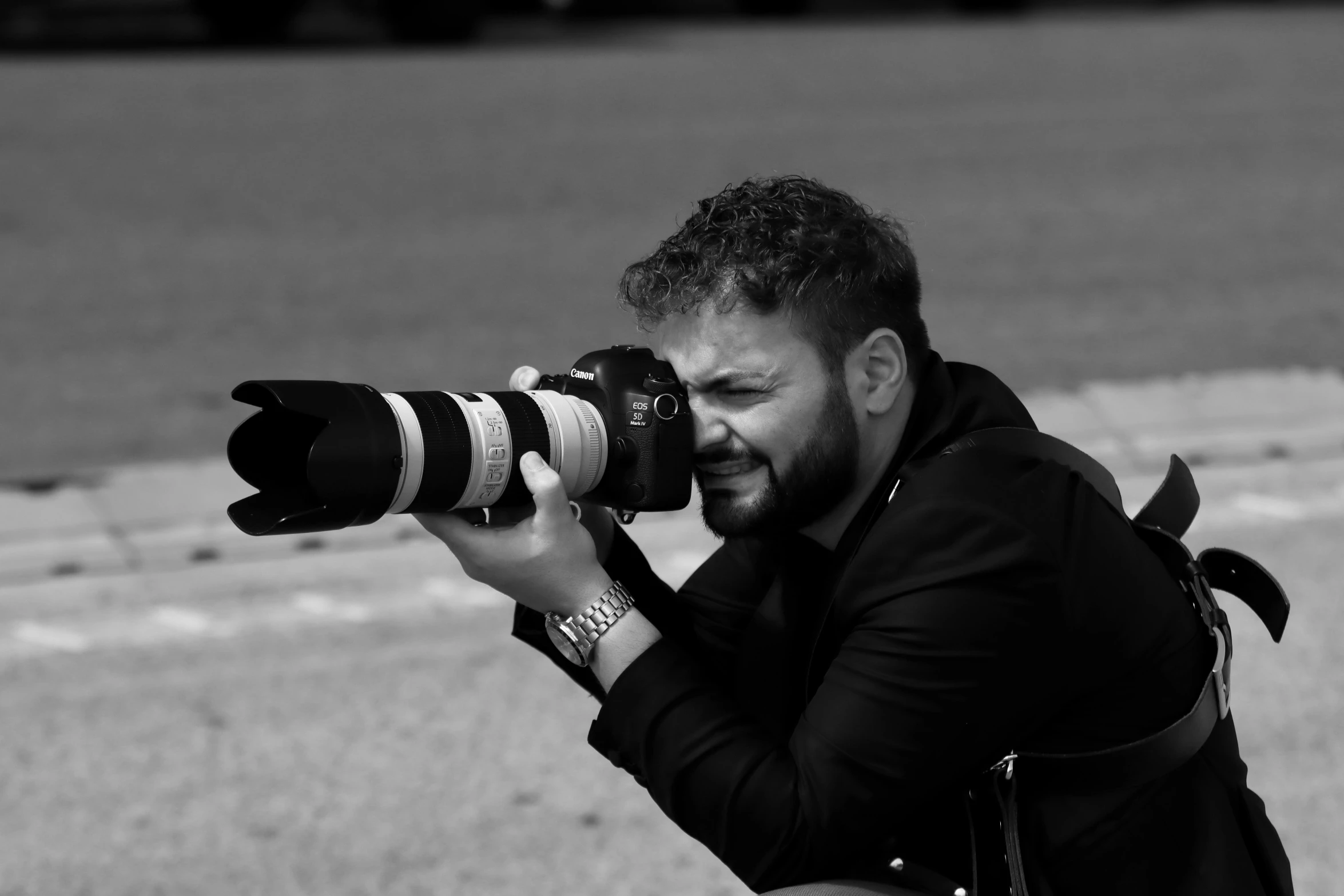 a black and white po of a man taking a picture