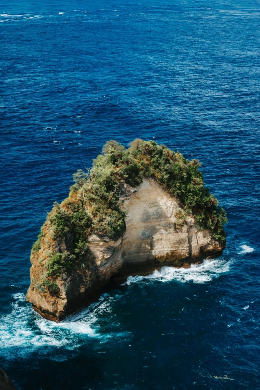 an island in the middle of the ocean surrounded by sea