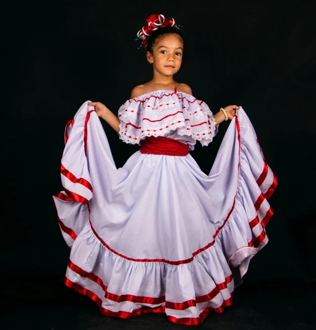 a  wearing a white dress with red trim