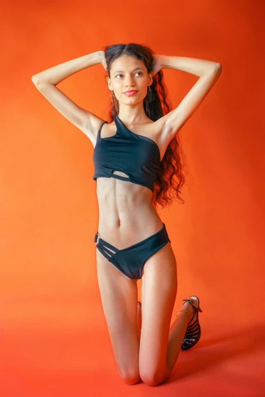 a beautiful young woman wearing a black swim suit