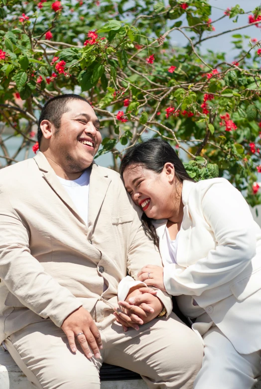 a man and a woman are sitting on a bench