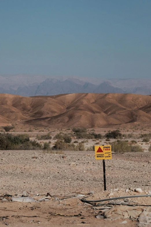 a desert scene with mountains in the distance