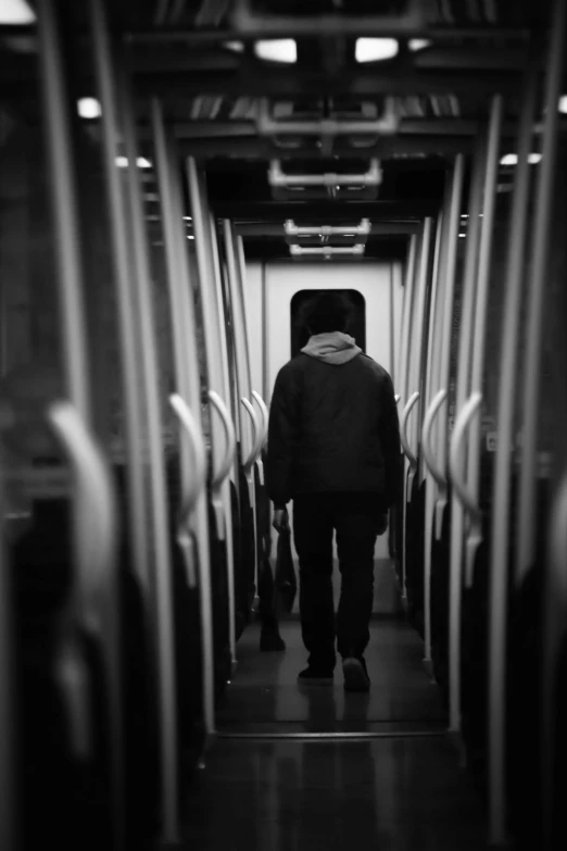 a man walking up the side of a long train