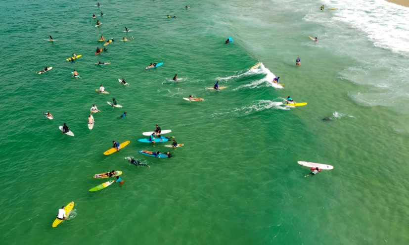 many people surfing on their surfboards in the water