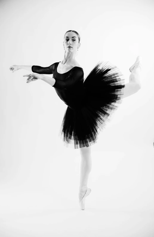 a ballerina is doing a ballet pose with black and white
