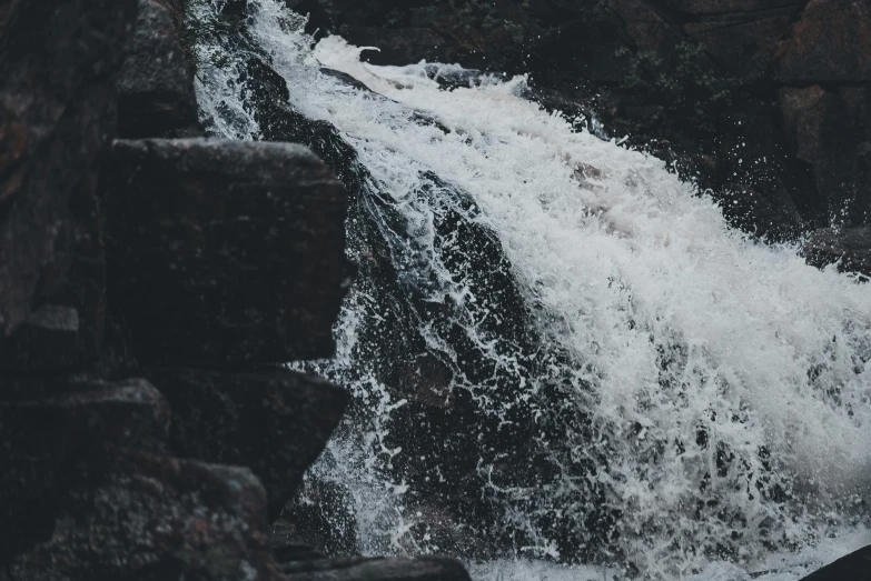 a person standing on top of water covered rocks