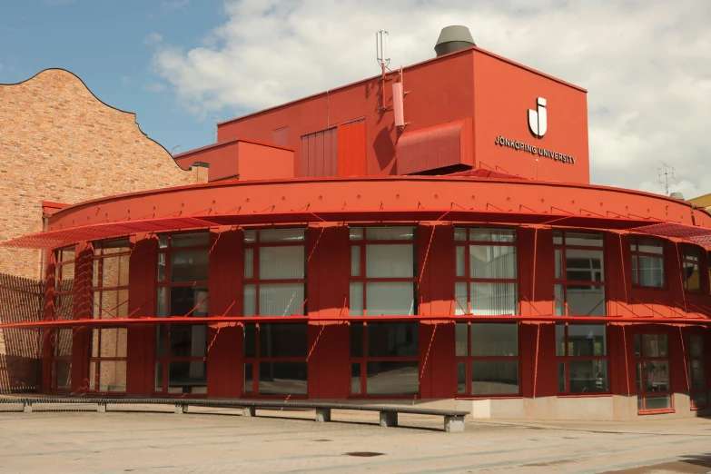 a large orange building with a round porch