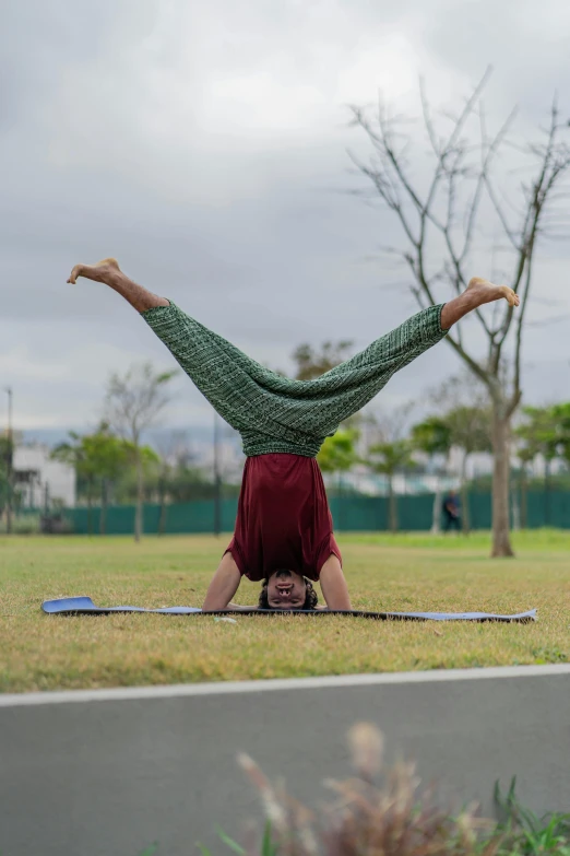 a person doing a handstand in the park