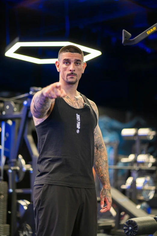 a man is standing in a gym doing some squat exercises