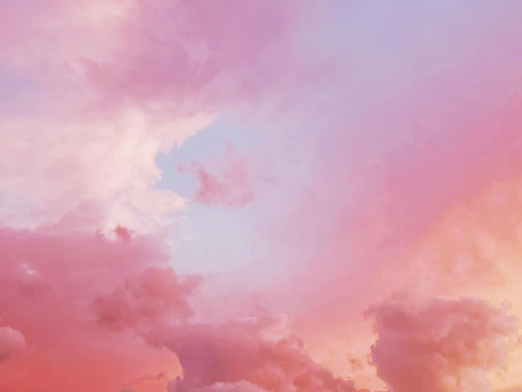 the sky is filled with pink and blue clouds