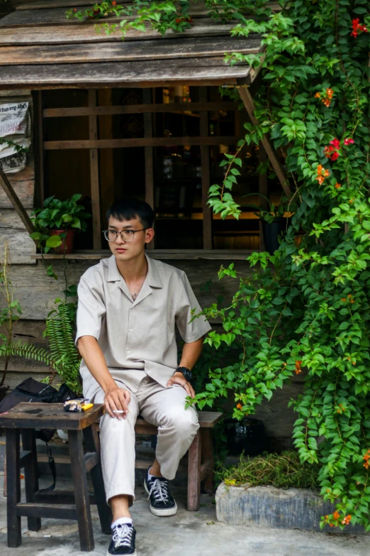 a man sitting on a bench next to a building