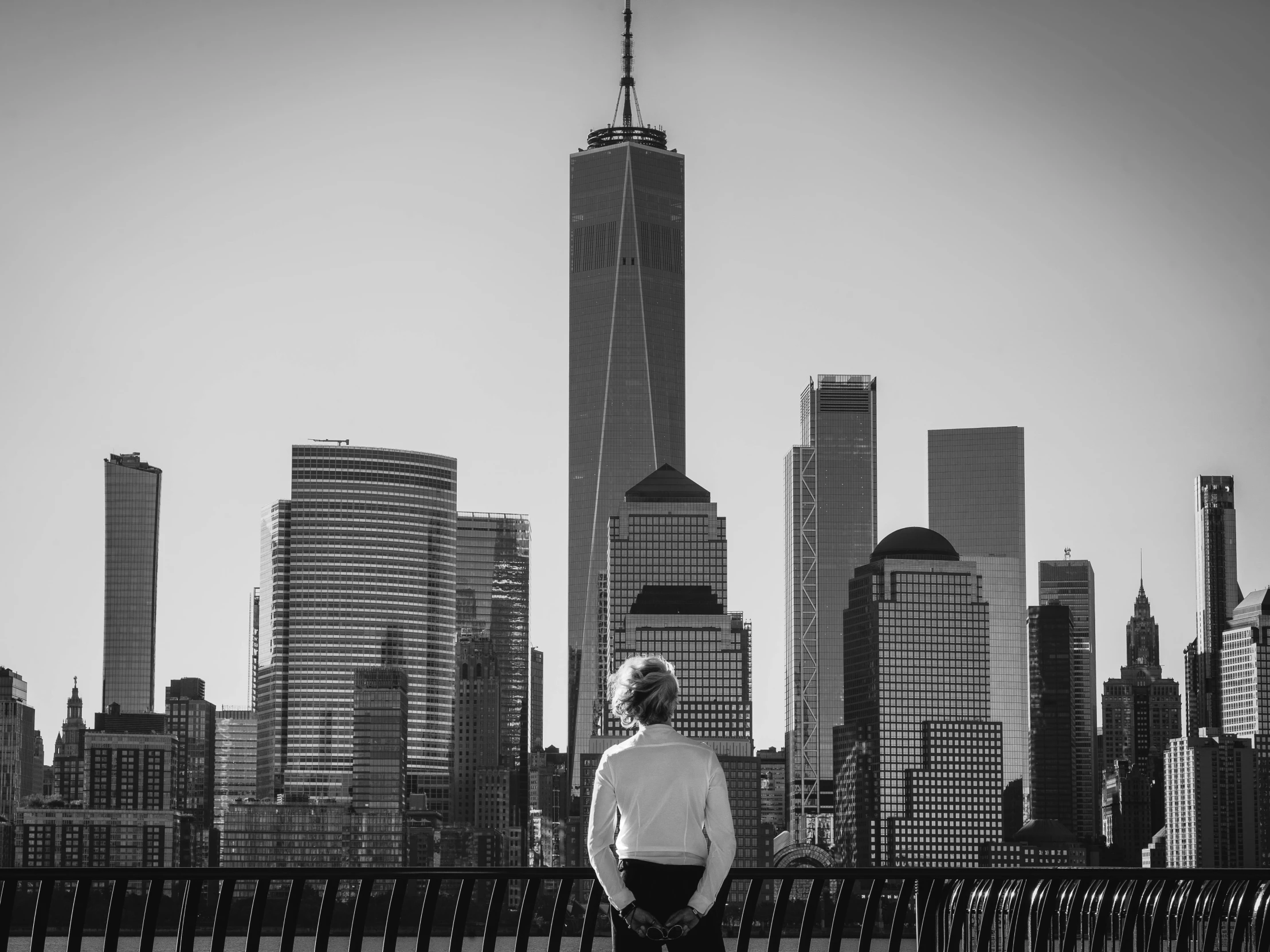 a man standing on a bench in front of cityscape