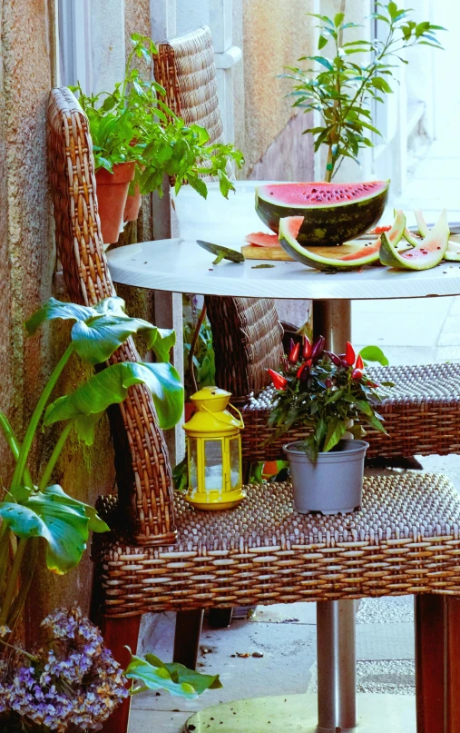 a chair sitting next to a table covered in fruit