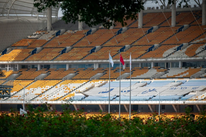 empty orange seats at an indoor stadium during the day