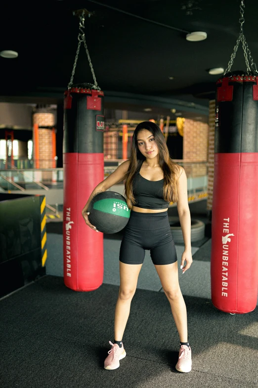 a woman standing in front of two punching gloves