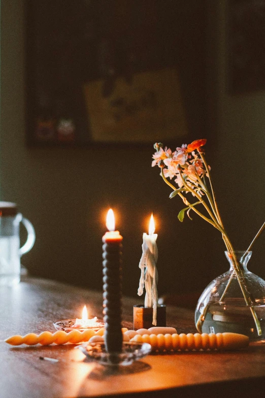 a candle and flowers on top of a table