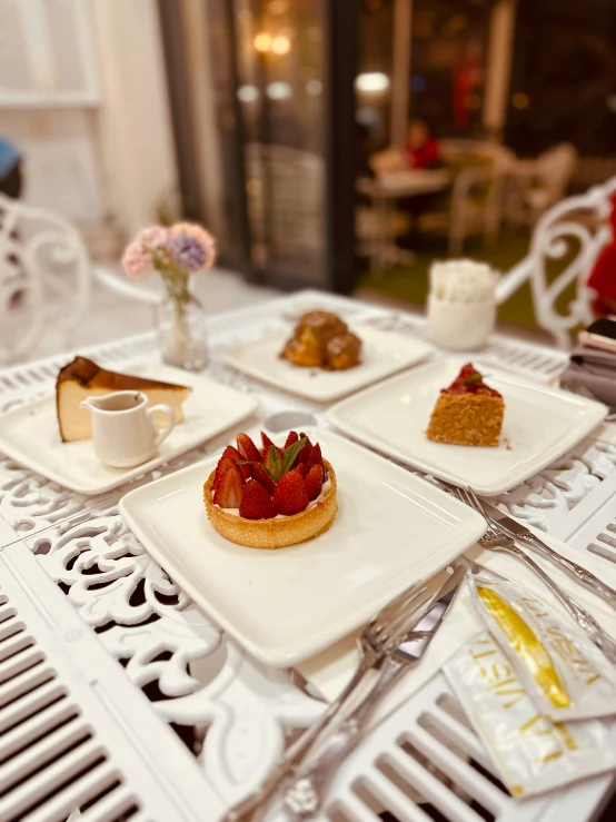 a white table topped with plates of food