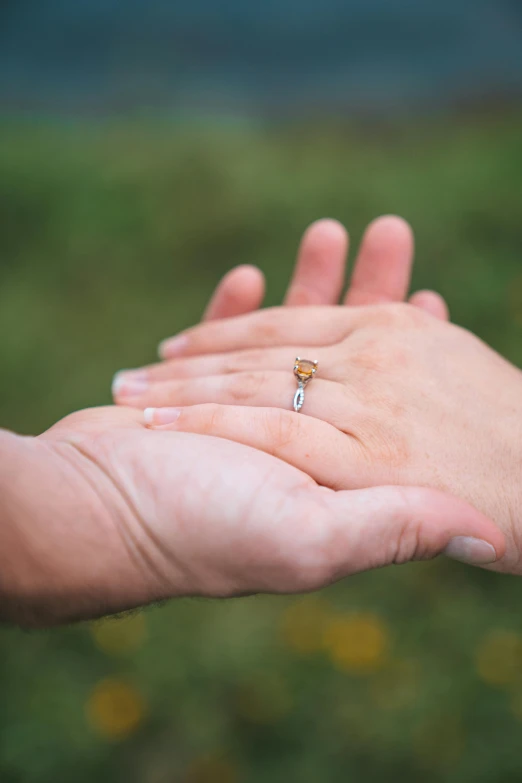 two people are holding hands with the other hand