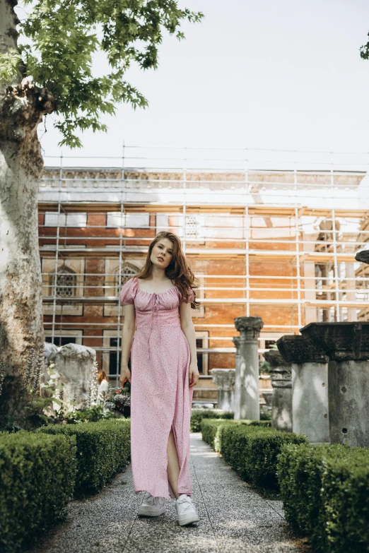 a woman posing in front of a building