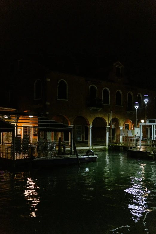 the buildings and lights are reflecting in the water