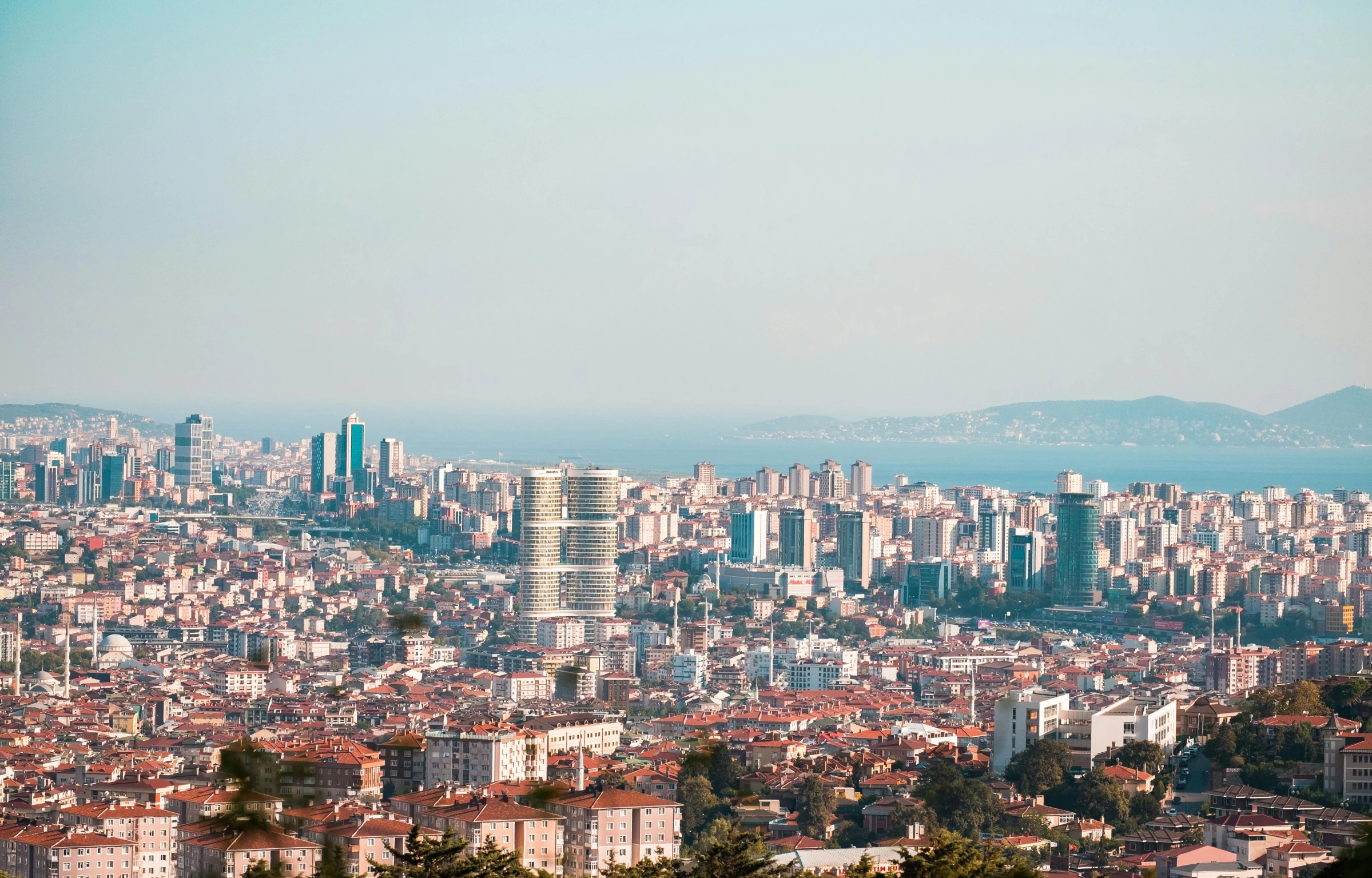 a city with mountains and tall buildings