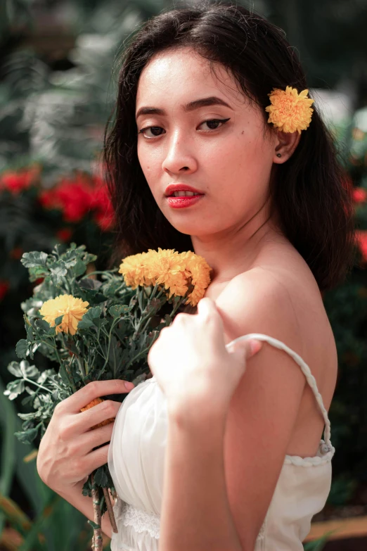 a  is holding flowers and smiling