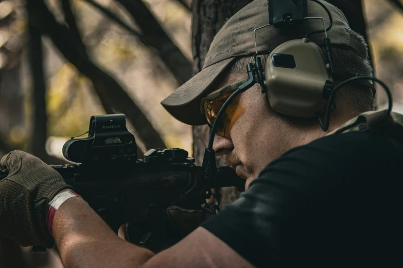 man aims his weapon with an adjustable rifle through the air