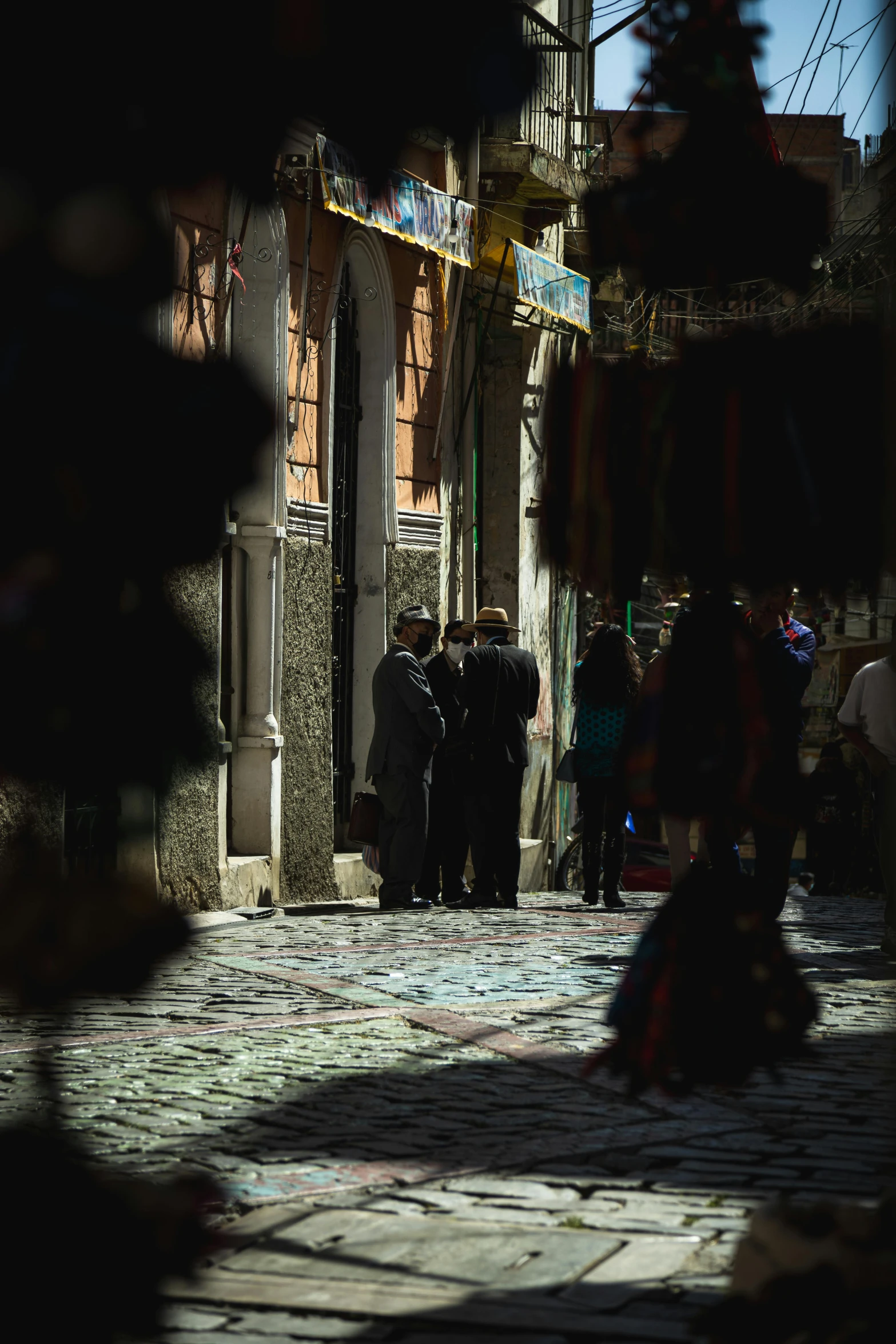 a couple of people walking in a alley way