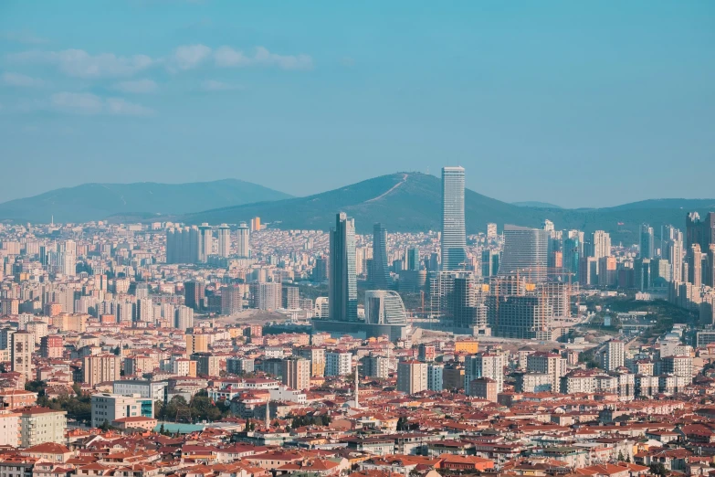 view of city buildings, mountains and distant sky