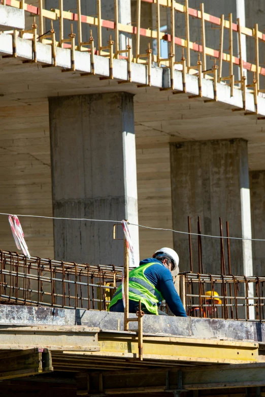 a construction worker standing at a wooden platform