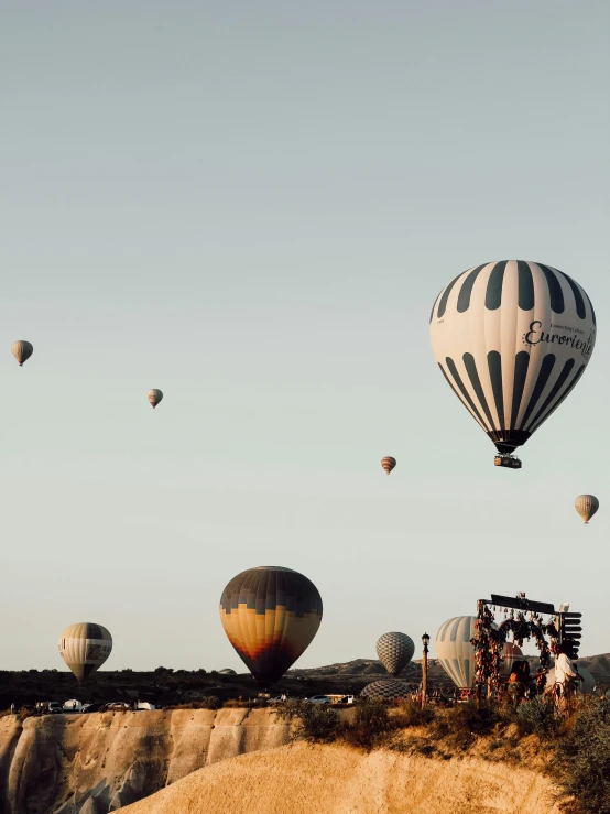 several  air balloons are in the sky