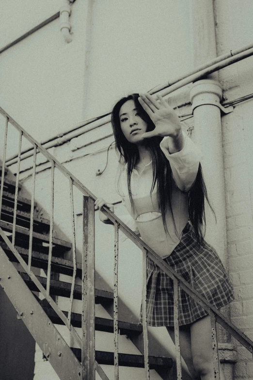 a girl is standing on the steps next to the banister