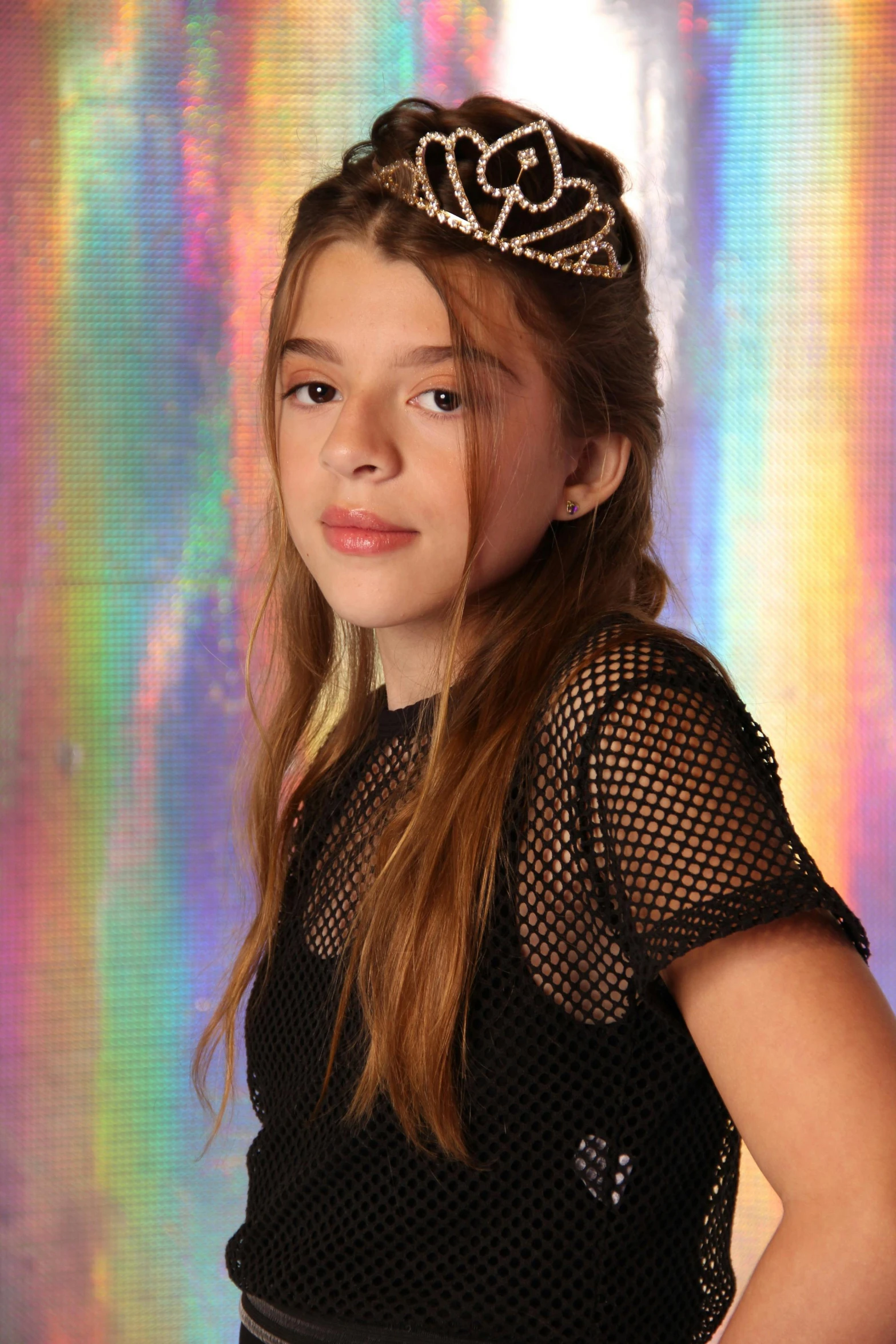 a  with a tiara looking at the camera