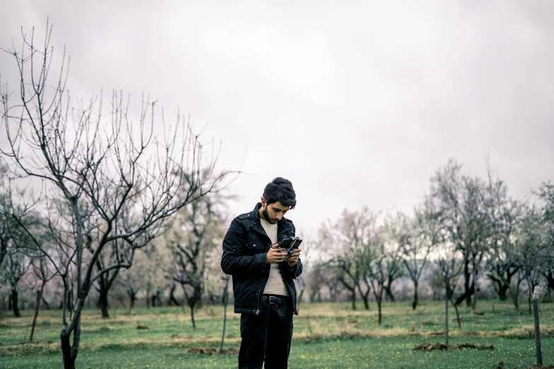 a man with a hat looking at his cellphone