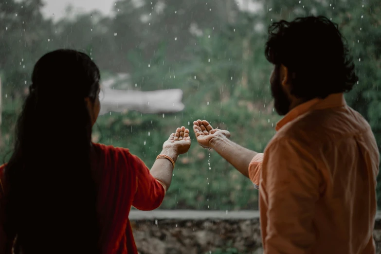 an asian couple are getting food together in the rain