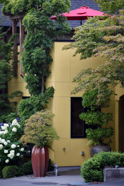 an elaborate planter in front of a large yellow building